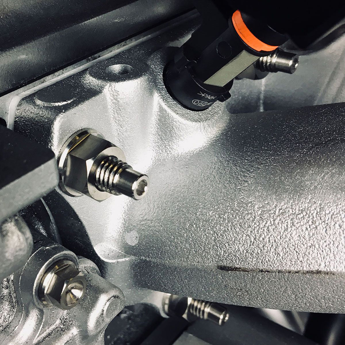 Titanium flanged manifold nut close up